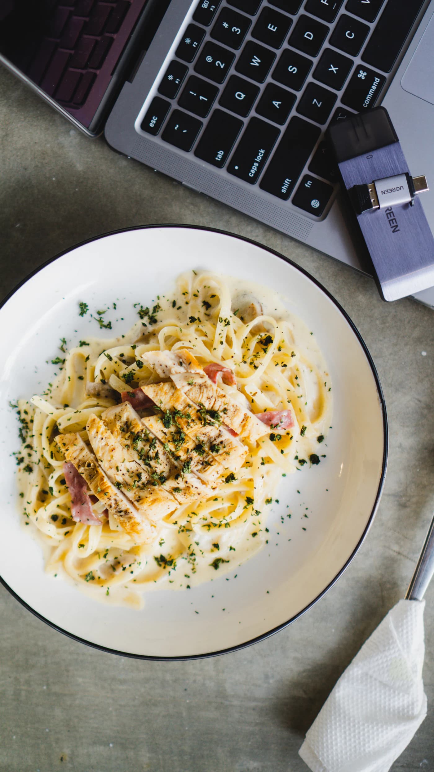 A comforting plate of creamy pasta with sliced chicken; representative food photography